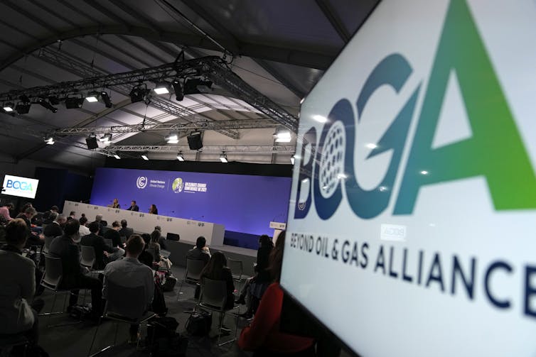A view of a conference set up and a screen on the right saying BOGA, Beyond Oil and Gas Alliance.