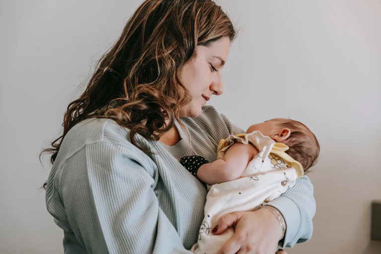 Mother holds newborn baby