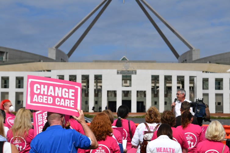 Aged care workers, whose wages ultimately depend on federal government funding, protest outside Parliament House, March 30, 2022. Their wages and conditions have not prospered with single-employer bargaining.