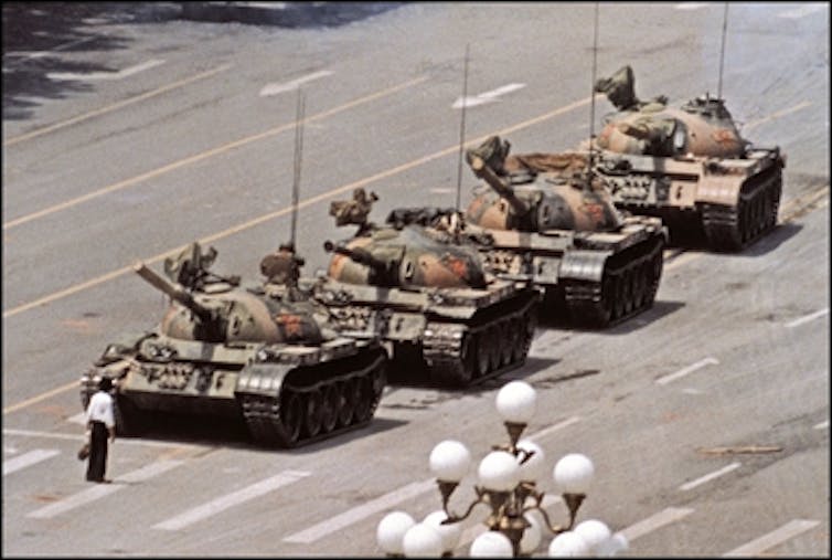 A Chinese protester stands ikn front of a line of tanks heading in to Tiananmen Square in Beijing, 1989.