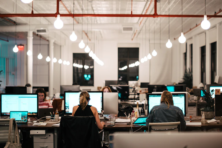 Office workers sit at computers