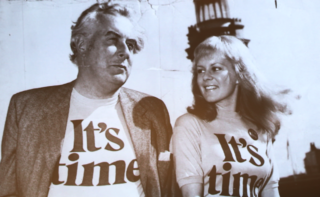 Gough Whitlam wearing an "It's Time" t-shirt next to a young woman