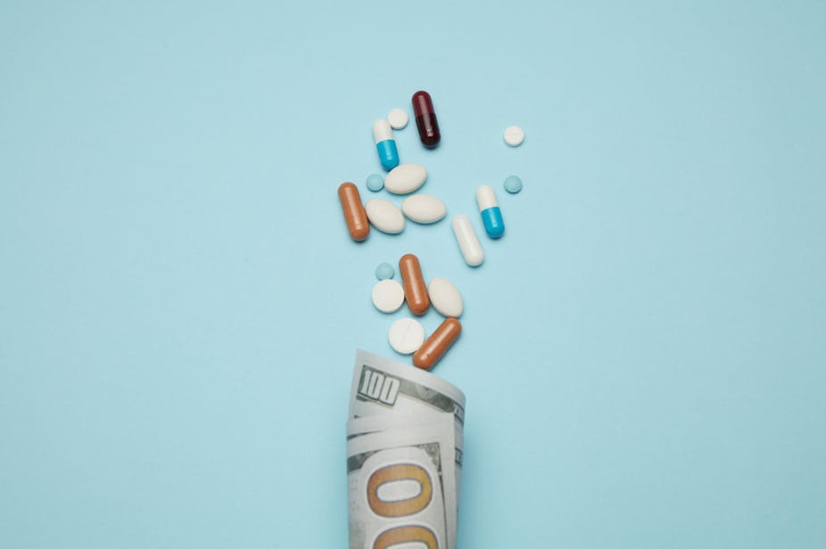 Illustration of a pills spilling out of a 100 value currency