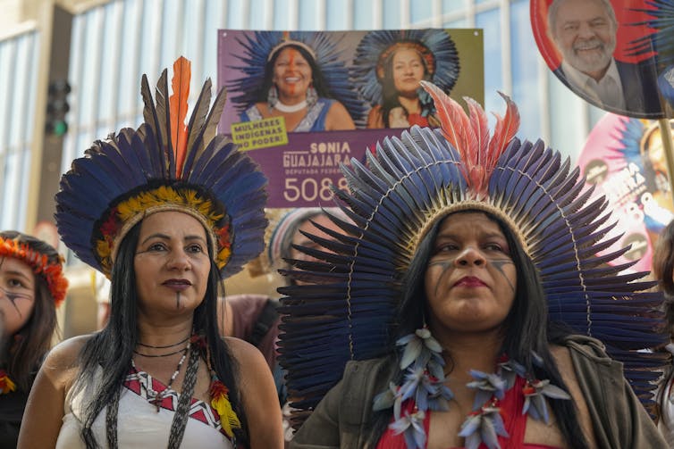 two woman in traditional attire at protest