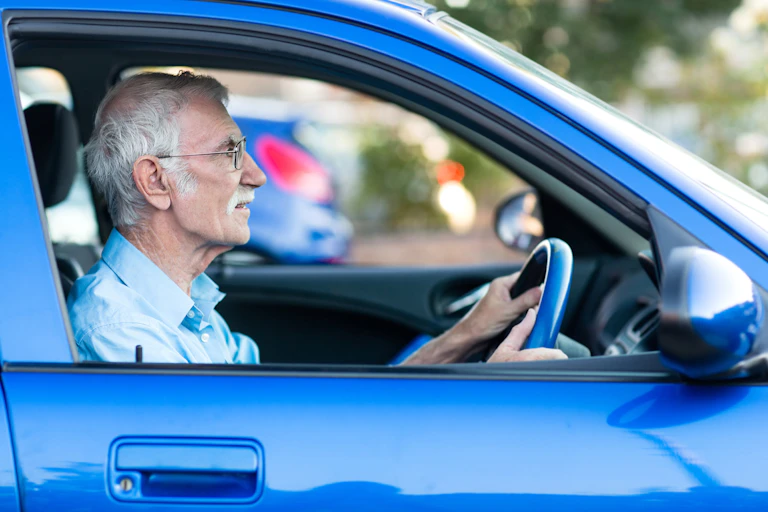 Older man drives a car