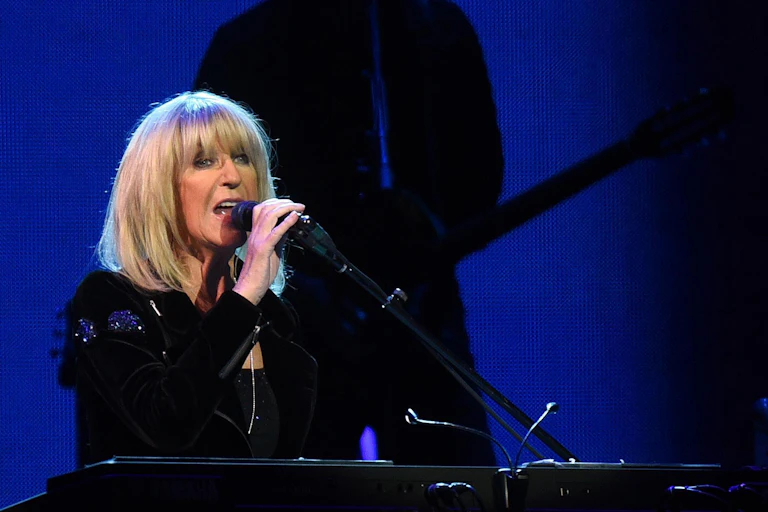 A woman sings at a piano.