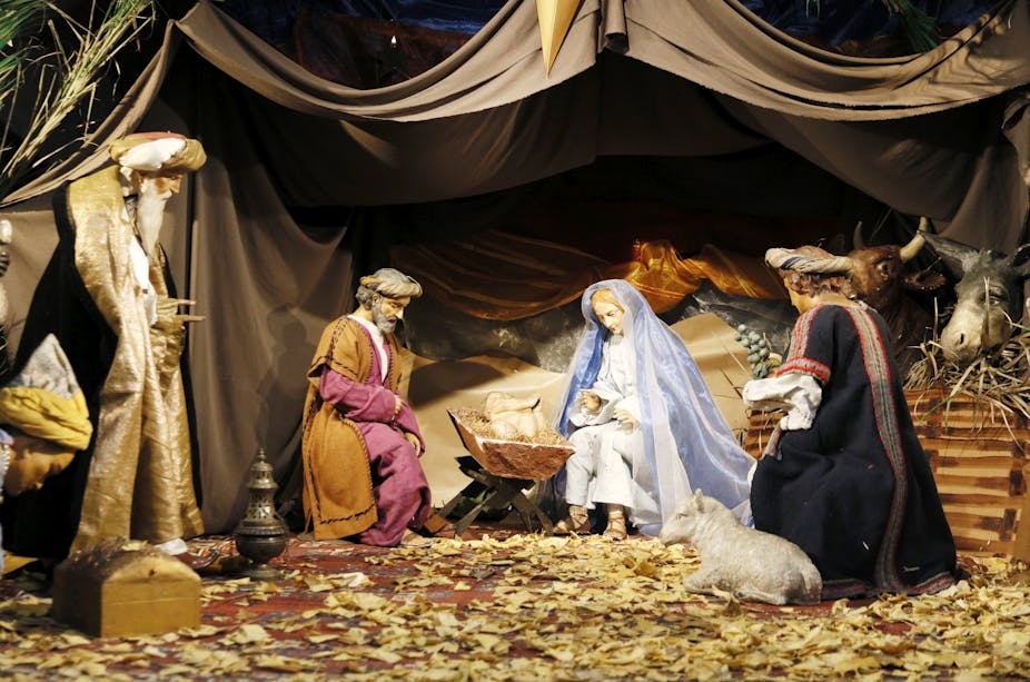A Nativity scene showing the three wise men visiting Mary, who is sitting in the manger with baby Christ.