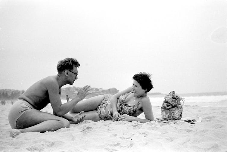 A man in shorts and a woman in a bikini.