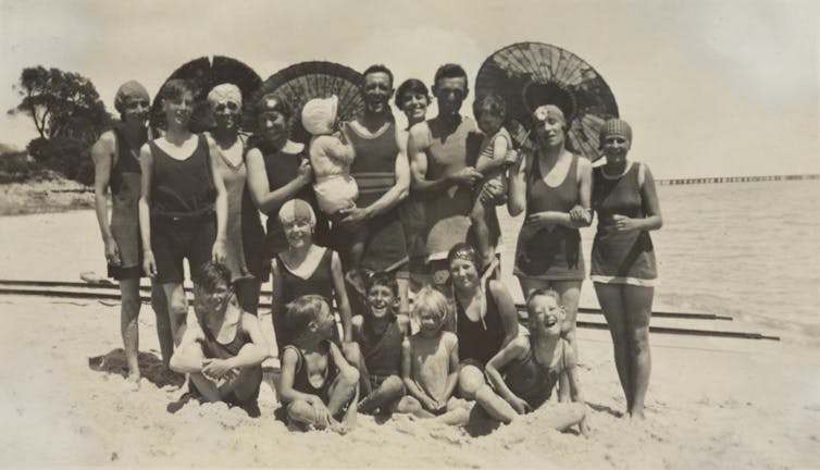 A happy crowd of people on the beach.