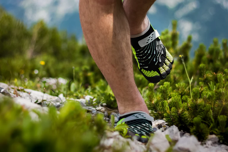 A person run's in barefoot shoes.