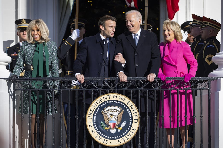Emmanuel Macron and Brigitte Macron (left) laugh with Joe Biden and Jill Biden (right) on a White House balcony during the French President's state visit.