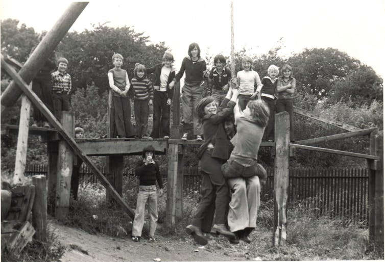 Children crowd on to a swing.