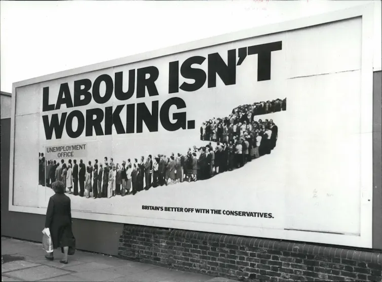 Woman walking past a billboard that says Labour Isn't Working