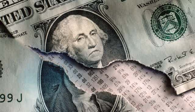 A ripped one-dollar bill has been doctored to show George Washington frowning.