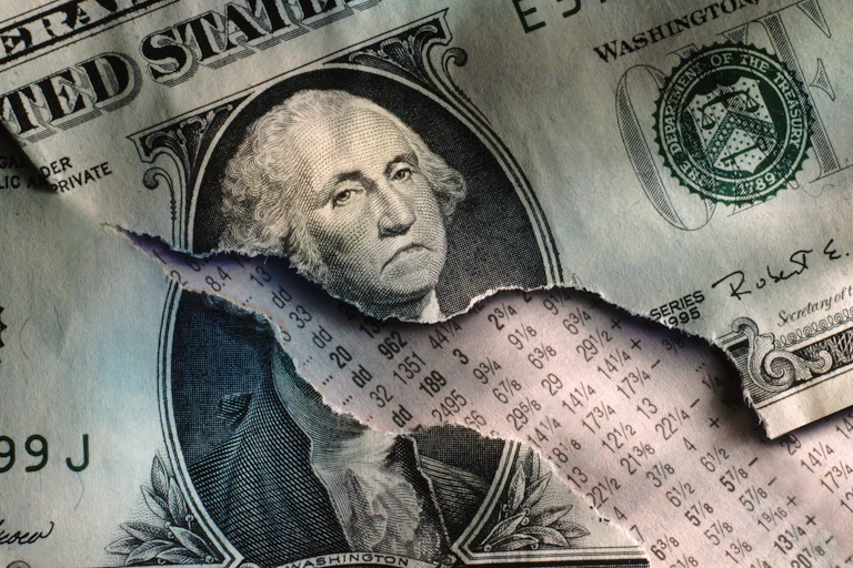 A ripped one-dollar bill has been doctored to show George Washington frowning.
