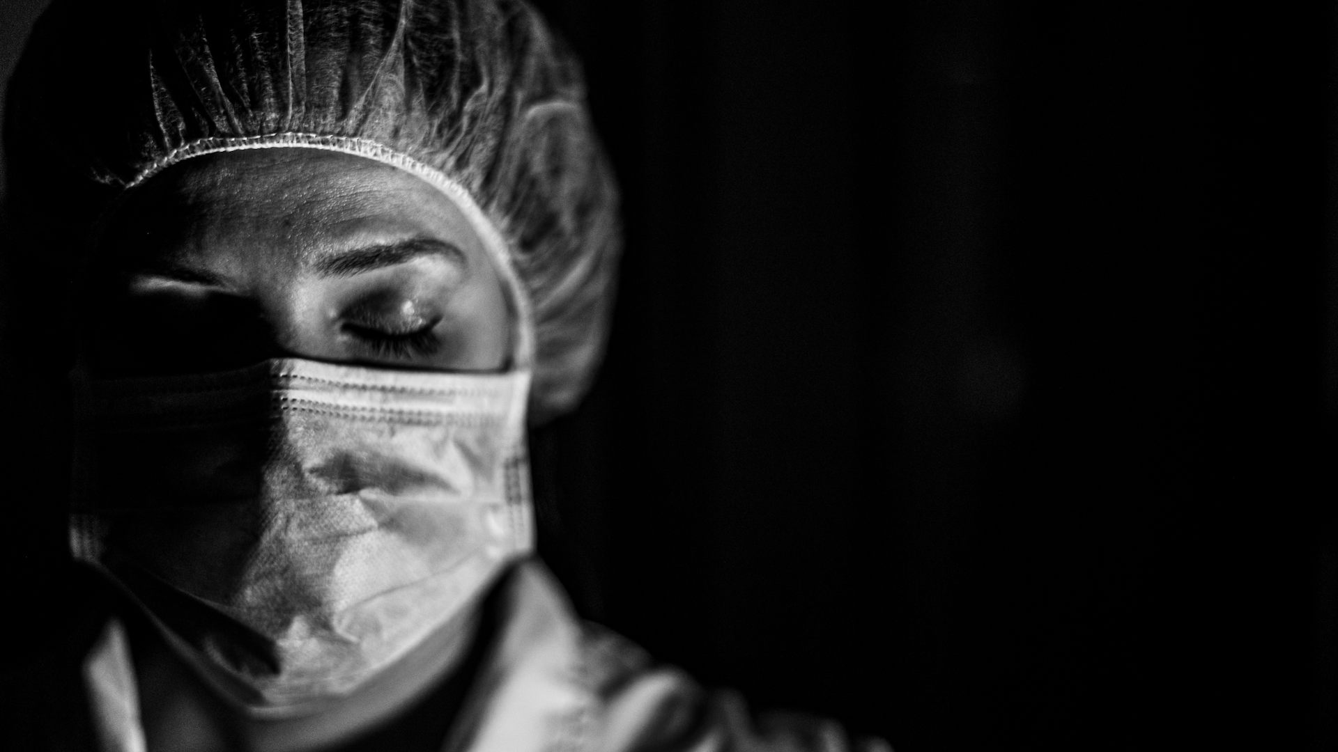 Black and white image of a nurse wearing a mask