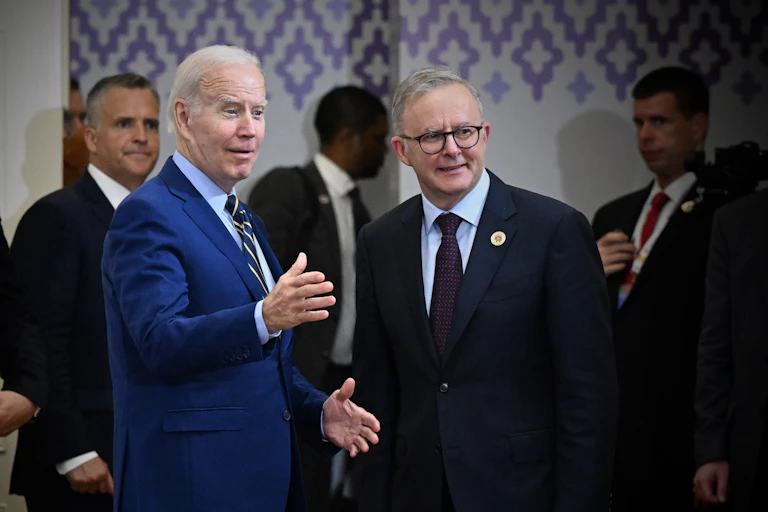 two men in suits look off camera