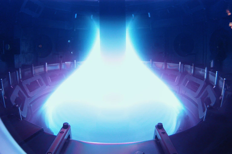 A bottle-shaped glowing blue and purple plasma shape in a spherical room
