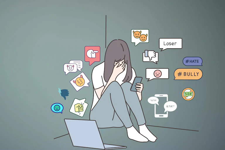 Sad young person sitting by laptop receiving abuse