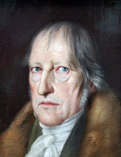 Close up portrait of Hegel's face shows a strong nose, blue eyes, ageing skin and a cravat paired with a brown fur jacket.