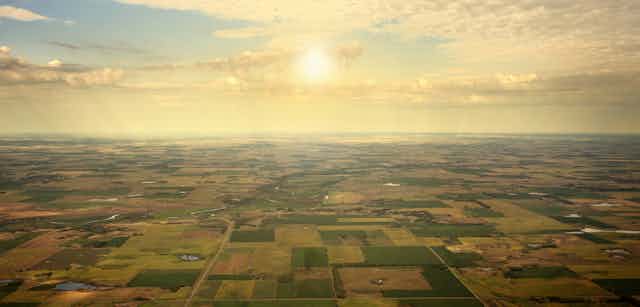 Aerial view of farmland at sunset