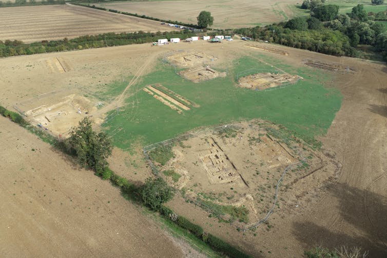 An aerial photograph shows the boundaries of the excavation area amid expansive rural fields.