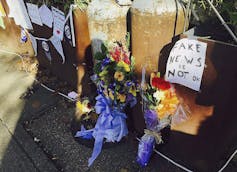 Flowers and notes are seen outside a resaturant.
