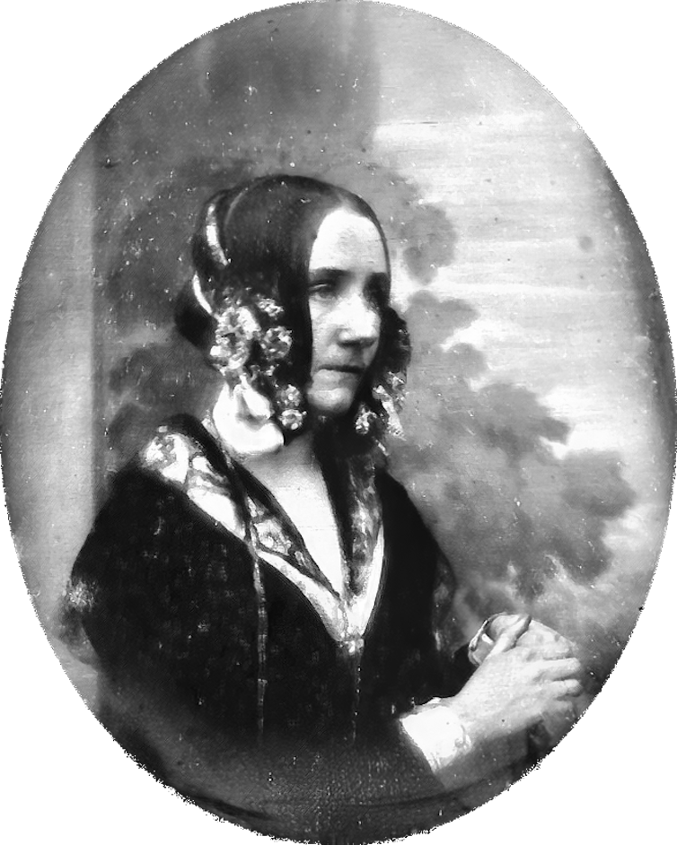 antique black-and-white photograph of a woman in an elaborate outfit
