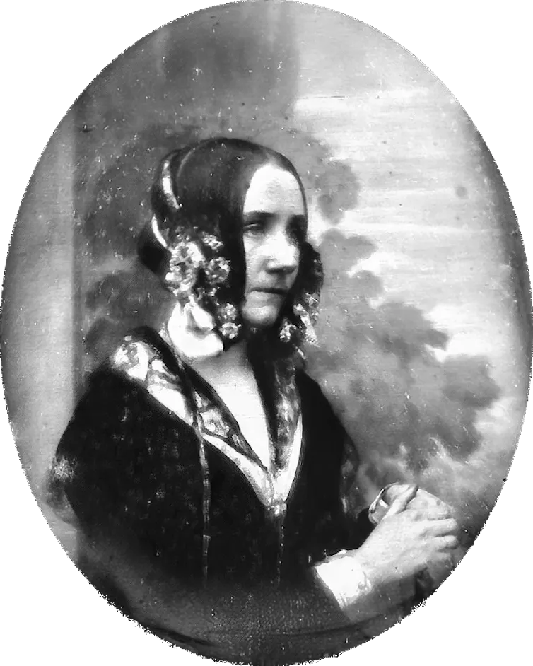 antique black-and-white photograph of a woman in an elaborate outfit