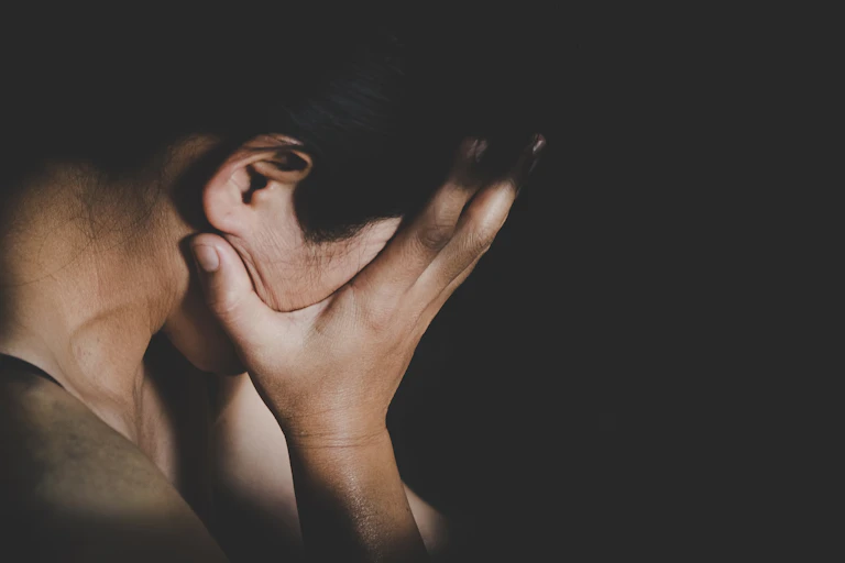 Woman puts her head in her hands