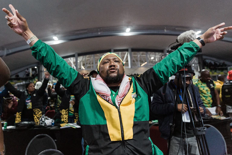 A man raises both hands in a joyous mood.