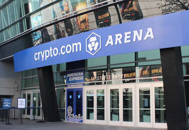 A blue sign says "Crypto.com Arena" above the 11th Street entrance to the LA stadium.