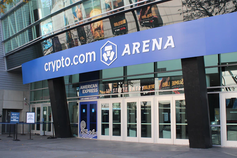 A blue sign says "Crypto.com Arena" above the 11th Street entrance to the LA stadium.