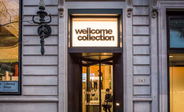 the main doors to the Wellcome Collection lit by a sign emblazoned with the museum's name