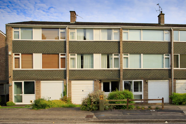 A row of terraced houses with large built in garages.