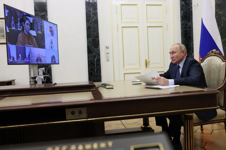 Russian president Vladimir Putin chairs a video meeting from his desk at the Kremlin.
