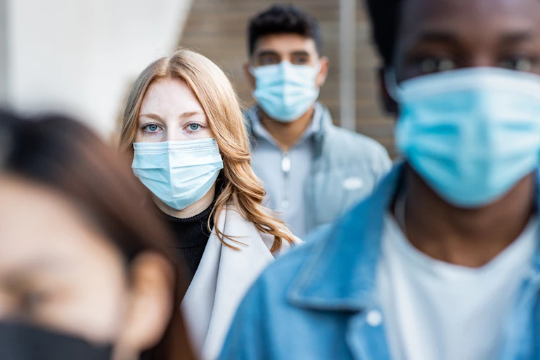 People walking close together wearing face masks