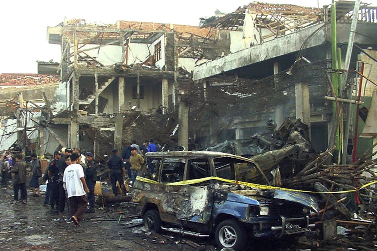 Police officers inspect the ruins of a nightclub destroyed by a bomb blast in Kuta, Bali, Indonesia, on Oct. 13, 2002