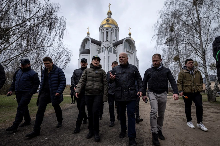 Karim Khan, la procureure ukrainienne Iryna Venediktova et d'autres enquêteurs devant une église