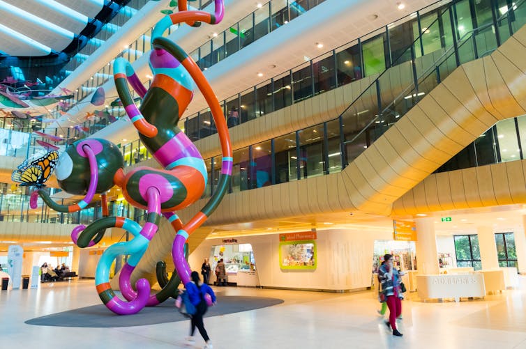 A giant, colourful sculpture in a hospital foyer.