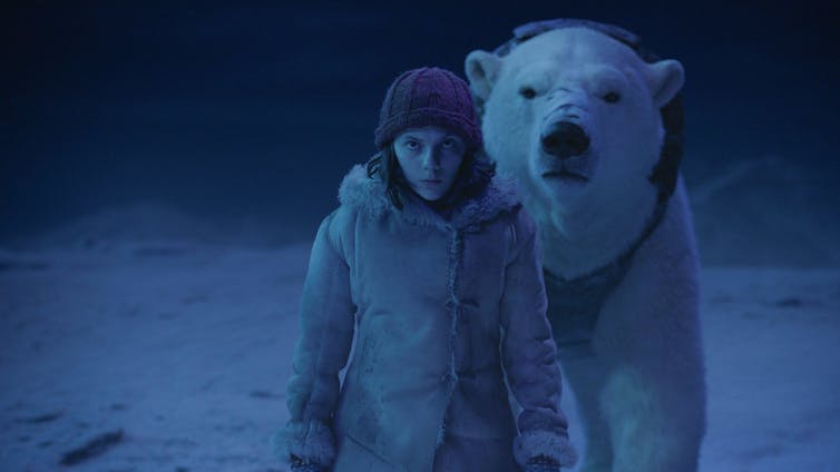 a girl in a parka and beanie with a polar bear