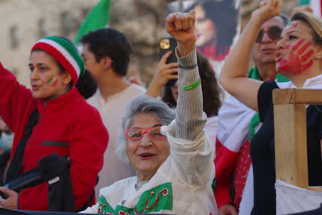 A woman with her fist in the air.
