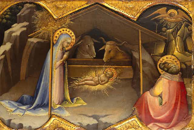 A painting with dark colors and gold shows Mary and Joseph in the manger with baby Jesus.