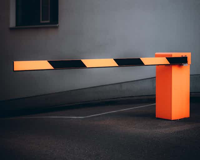 A yellow and black striped road barrier