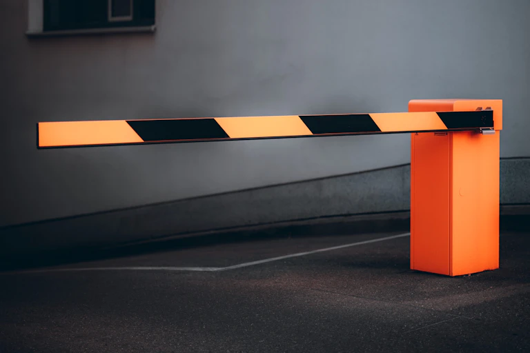 A yellow and black striped road barrier