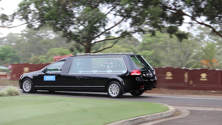 black hearse at cemetery