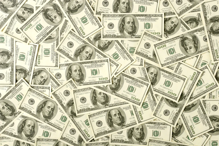 A collage of dozens of $100 bills.