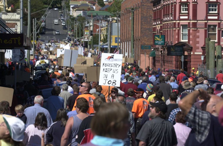 people rally with sign 'Forestry keeps us ina job'