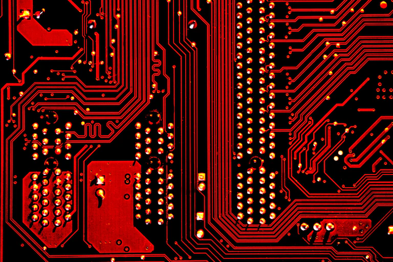 The red and black design of a computer motherboard.