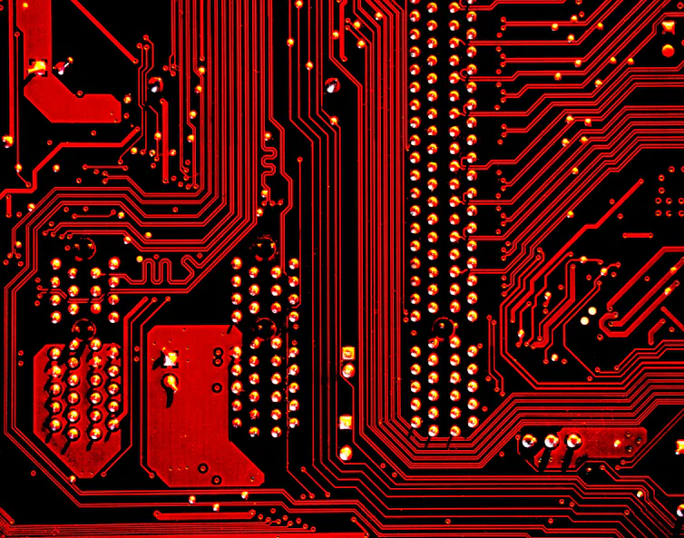 The red and black design of a computer motherboard.